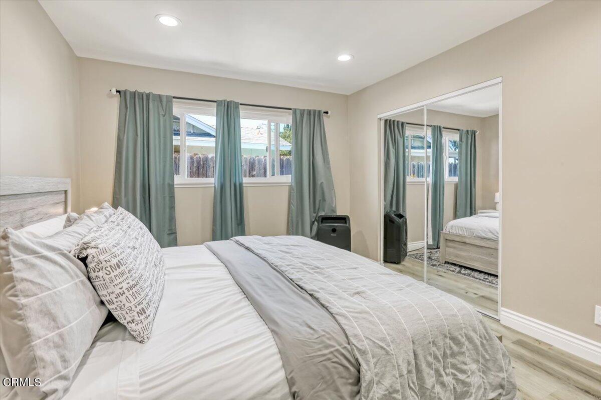 635 Oleander Drive Oxnard, CA 93033 - Photo 32 of 37 a bedroom with a large bed and a large window