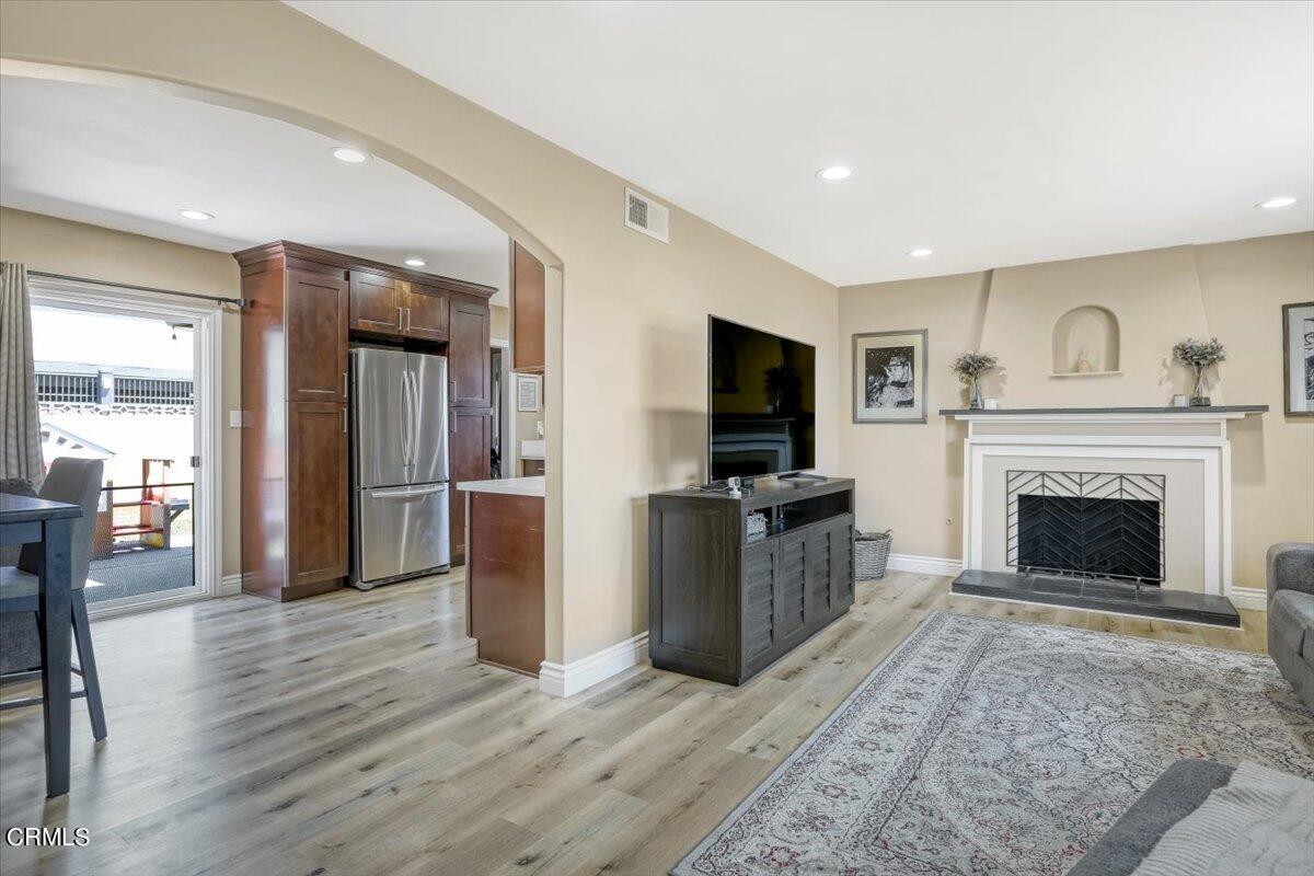 635 Oleander Drive Oxnard, CA 93033 - Photo 9 of 37 a living room with furniture a flat screen tv and a fireplace