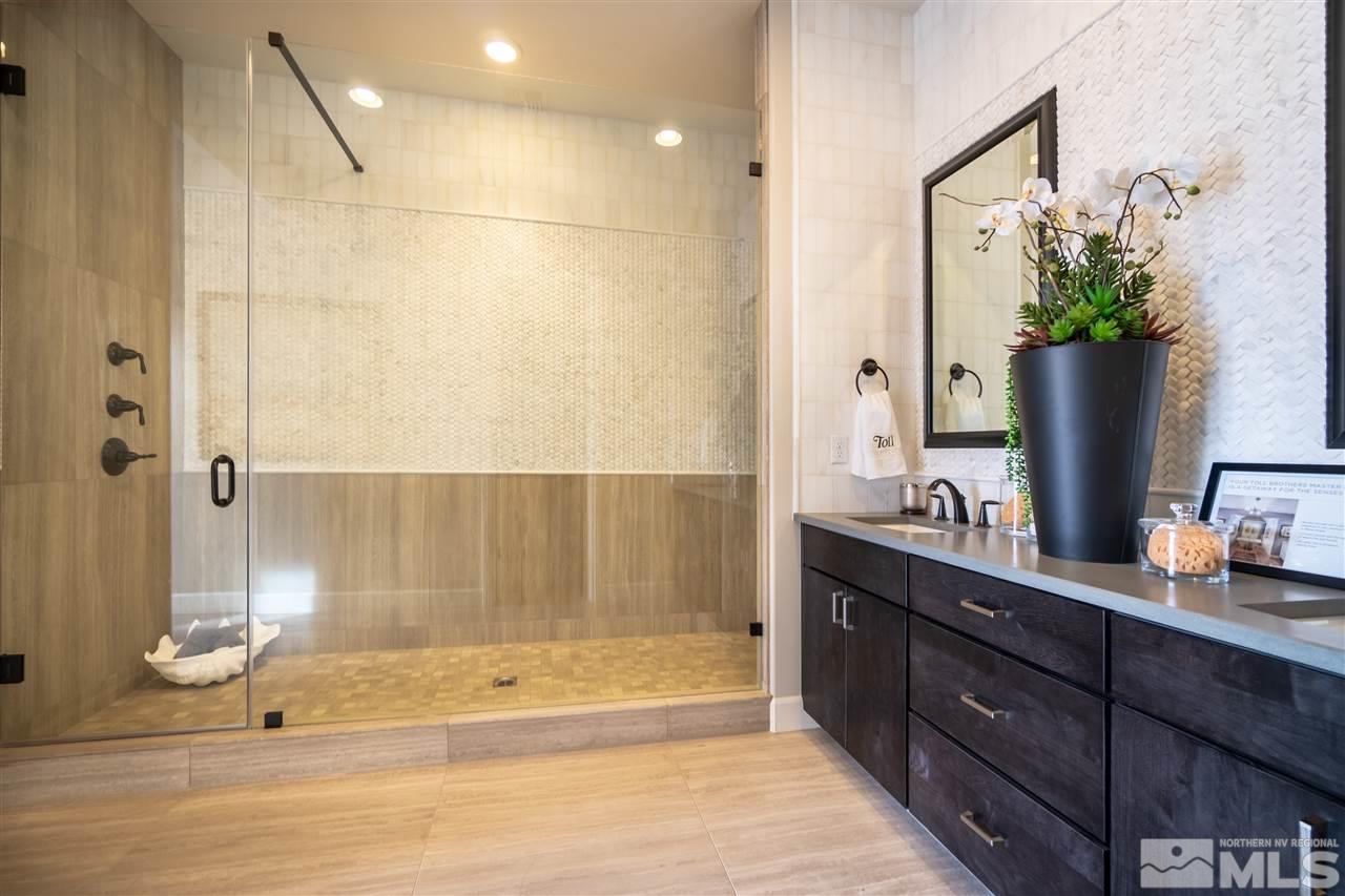 2860 Ethelinda Way, Unit LOT 13 Reno, NV 89521 - Photo 12 of 23 a bathroom with a granite countertop sink a mirror and a shower