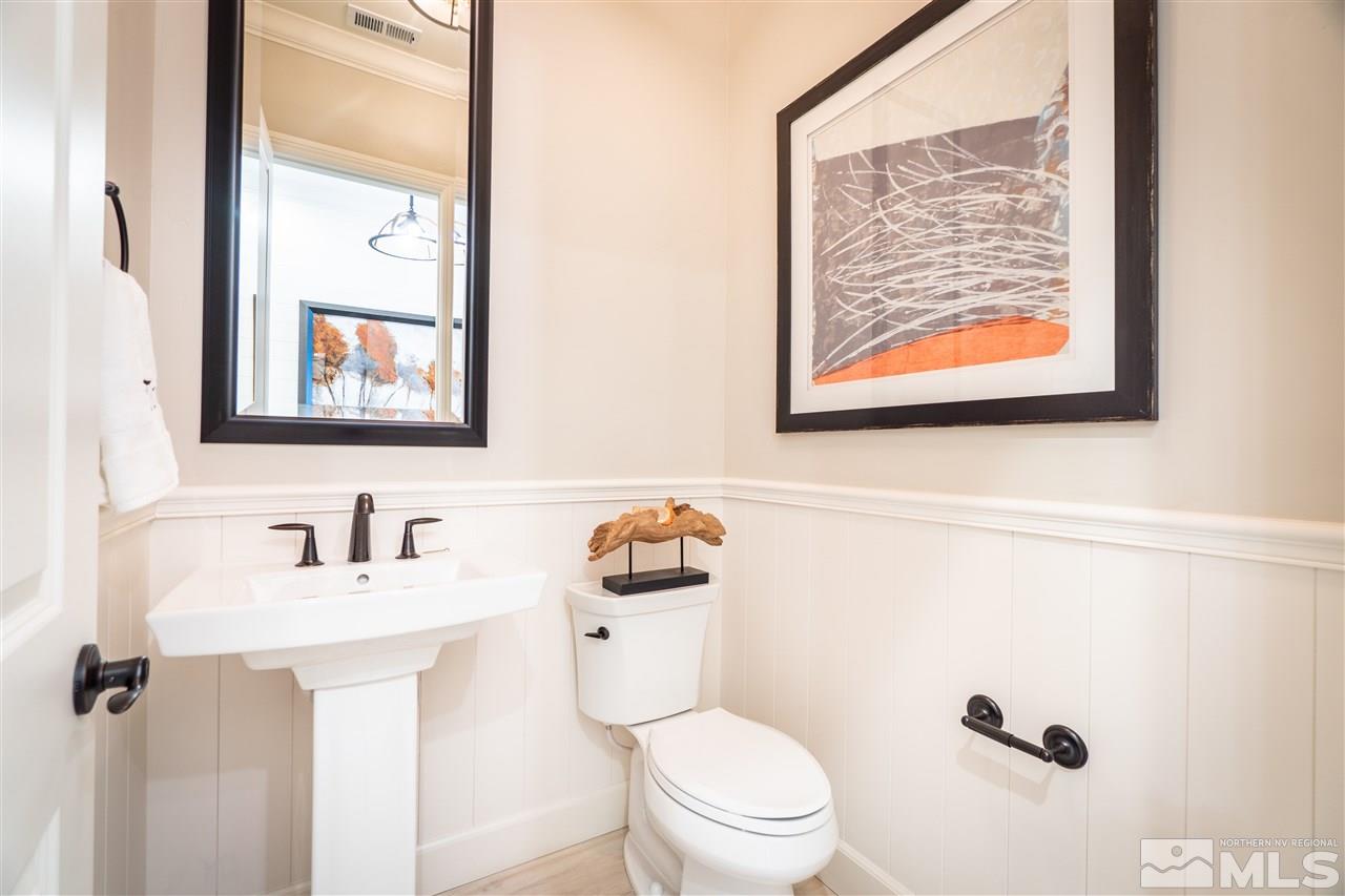 2860 Ethelinda Way, Unit LOT 13 Reno, NV 89521 - Photo 17 of 23 a bathroom with a toilet a sink and mirror