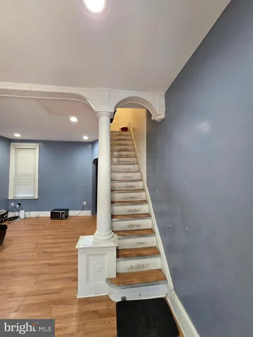 a view of entryway and hall with wooden floor