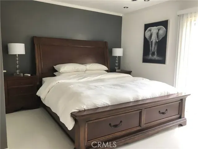 a bedroom with a bed and mirror