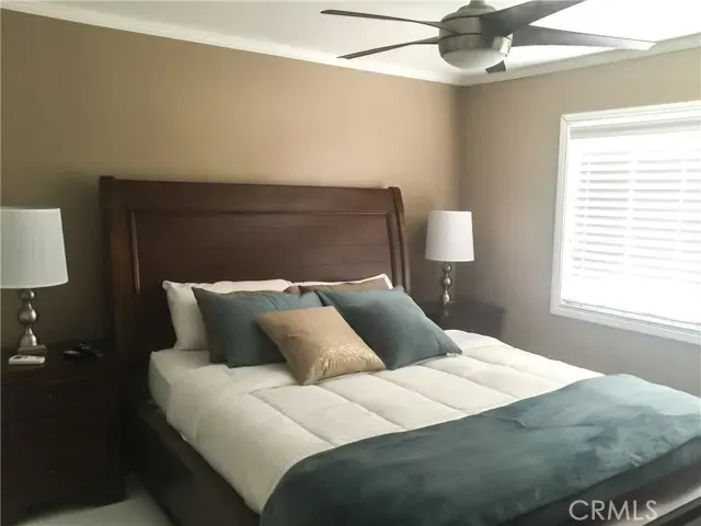 a bedroom with a bed and a lamp