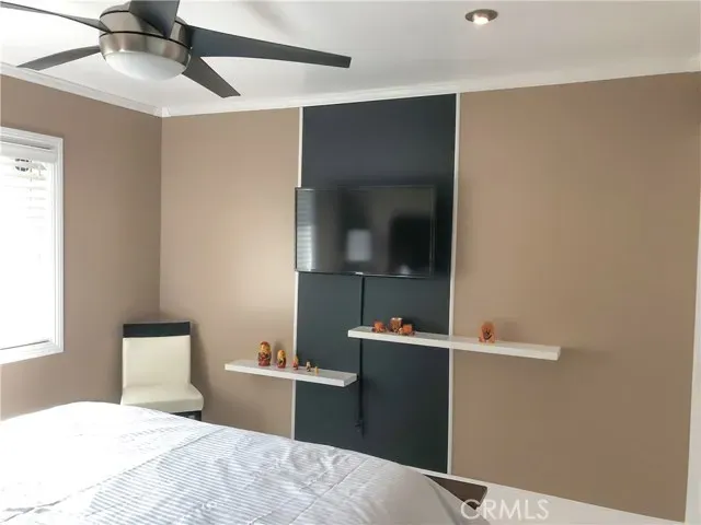 a bedroom with a bed and a mirror