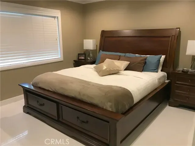 a bedroom with a bed and window