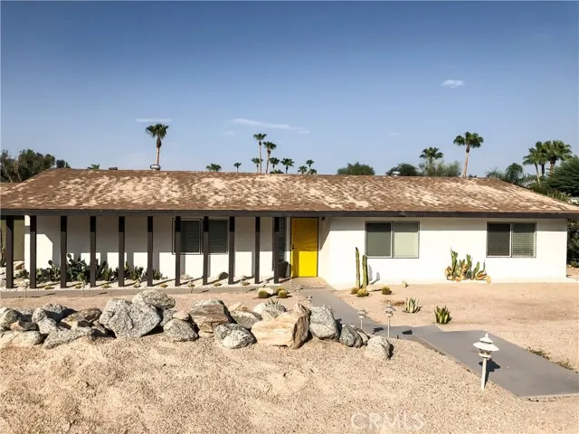 71292 Biskra Road Rancho Mirage, CA 92270 - Photo 22 of 27 a front view of a house with a yard
