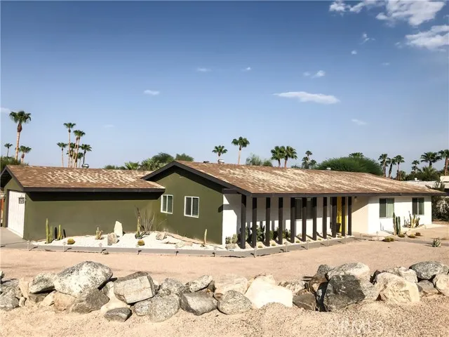 71292 Biskra Road Rancho Mirage, CA 92270 - Photo 23 of 27 a view of a house with a yard covered in snow