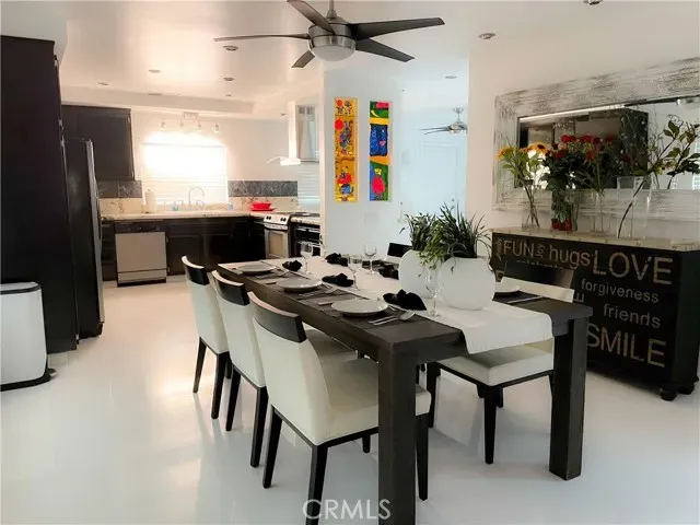 a kitchen with a table chairs and a refrigerator