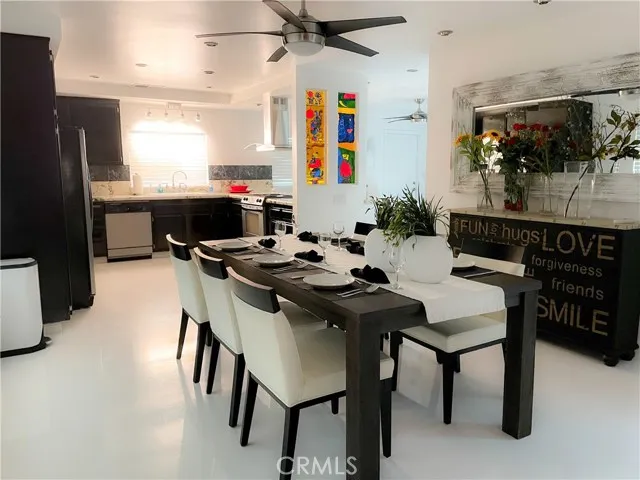 71292 Biskra Road Rancho Mirage, CA 92270 - Photo 5 of 27 a kitchen with a table chairs and a refrigerator