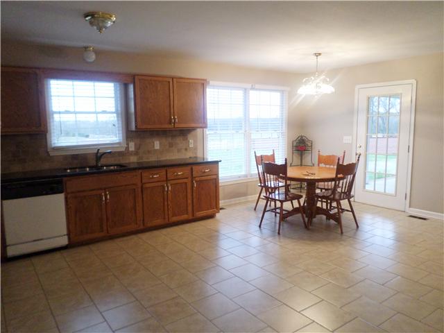 1156 Young Road Lebanon, TN 37090 - Photo 16 of 20 a large kitchen with kitchen island a sink table and chairs