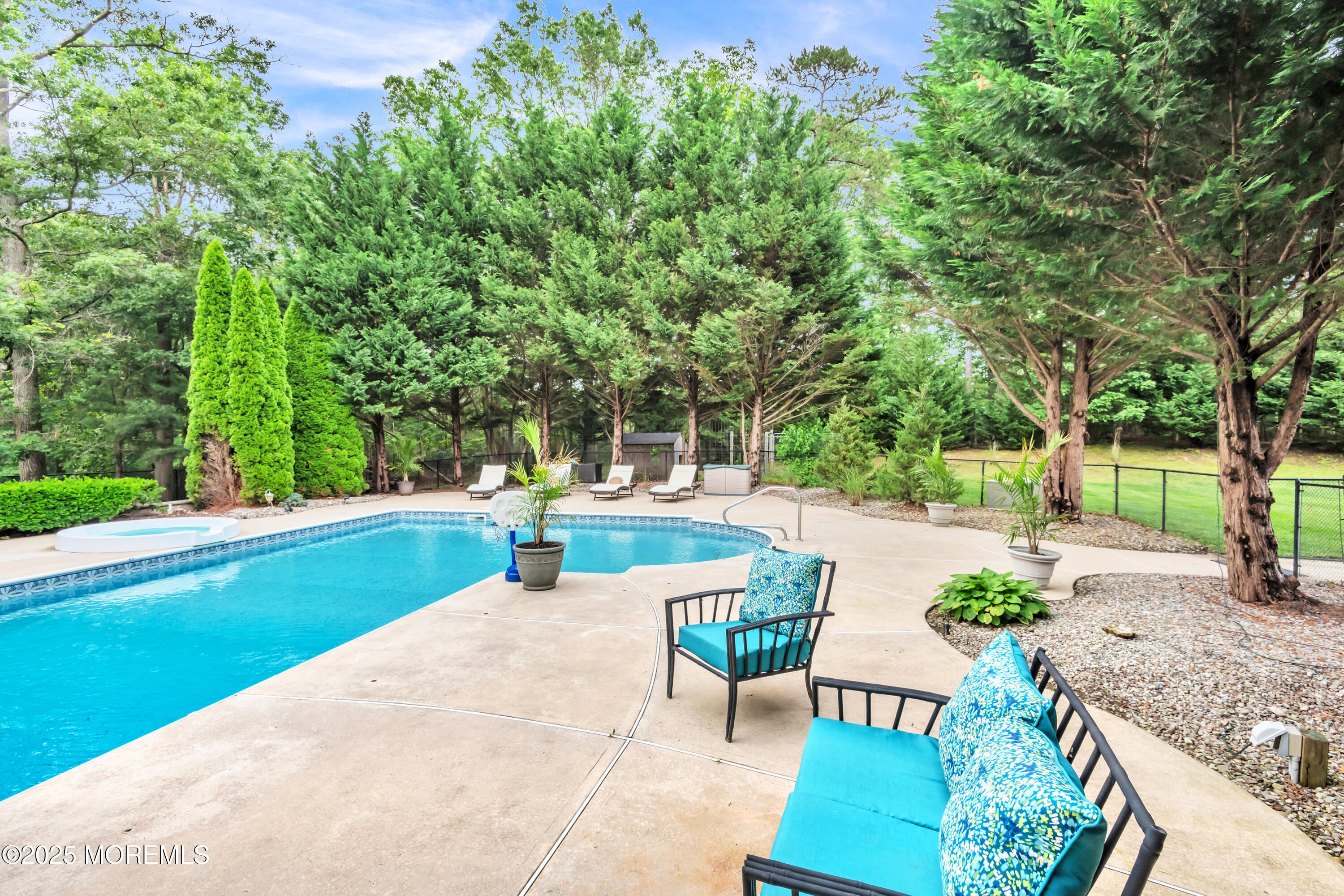 15 Conor Road Jackson, NJ 08527 - Photo 21 of 77 a view of a patio with table and chairs potted plants and a large tree