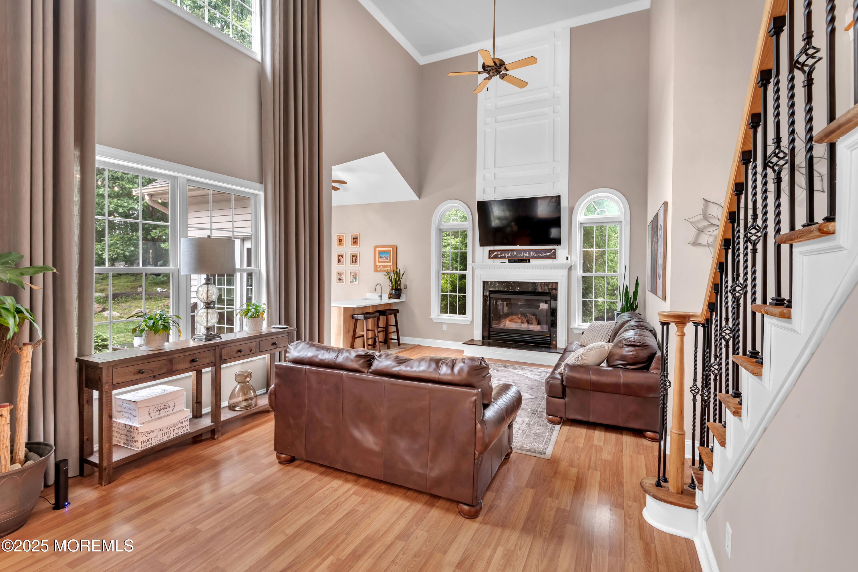 15 Conor Road Jackson, NJ 08527 - Photo 46 of 77 a living room with furniture a fireplace and a flat screen tv