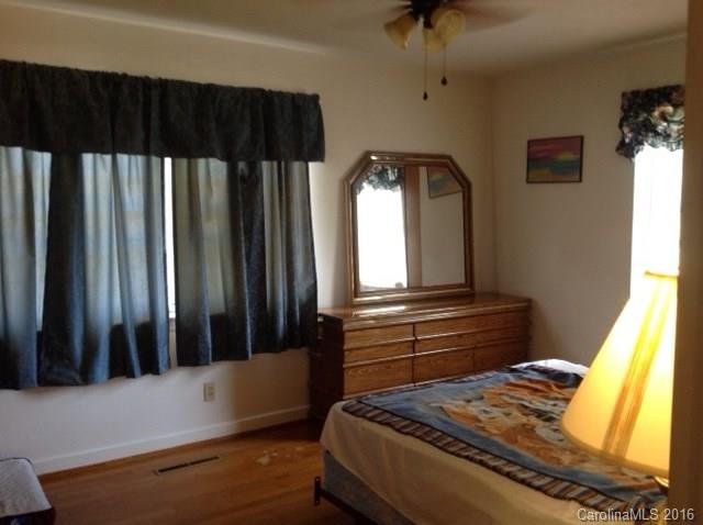 4205 River Road Hickory, NC 28602 - Photo 7 of 22 a bedroom with a bed and a chandelier
