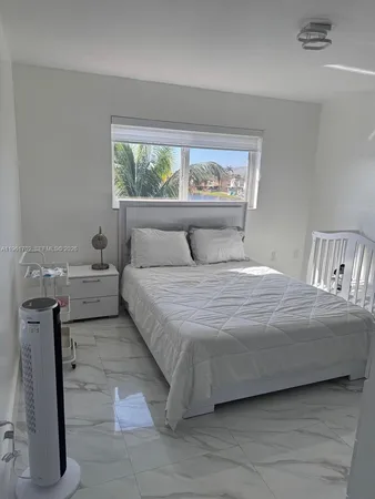 a bedroom with a bed and window