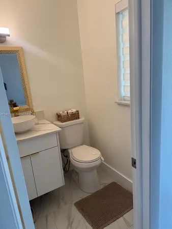 a bathroom with a toilet a sink and a mirror