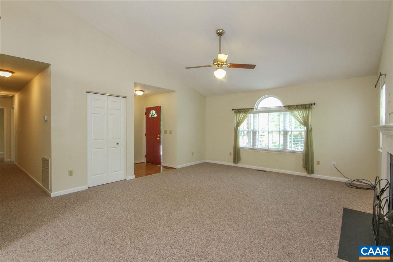 13 Deer Path Road Palmyra, VA 22963 - Photo 5 of 17 an empty room with windows and chandelier fan