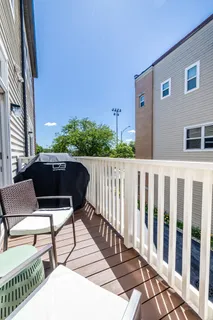 a roof deck with table and chairs and wooden floor