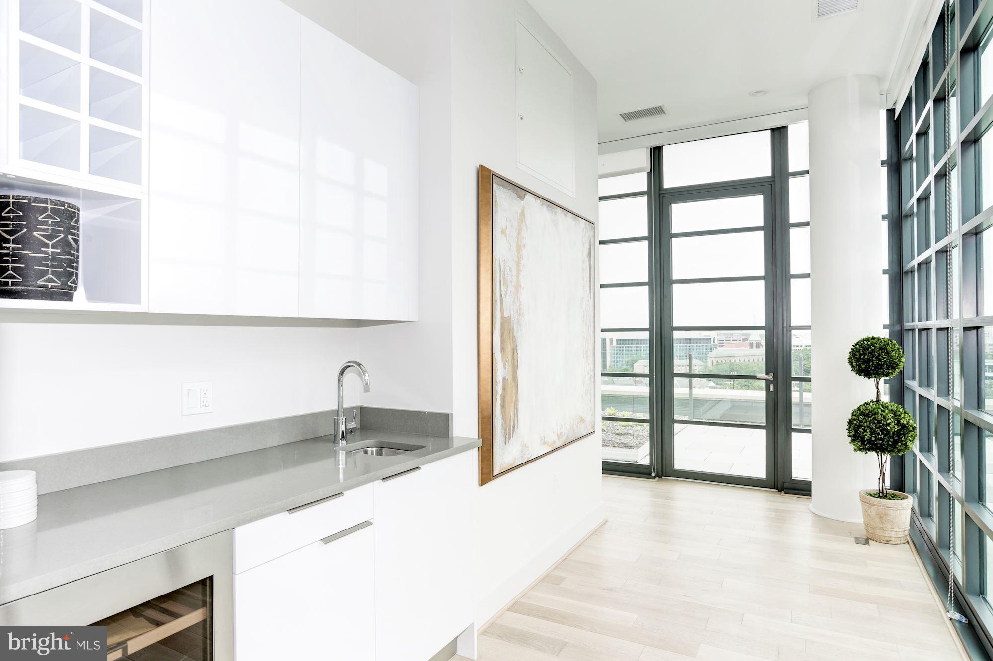 45 Sutton Square Southwest, Unit PH20 Washington, DC 20024 - Photo 11 of 21 a room with a large window and potted plants