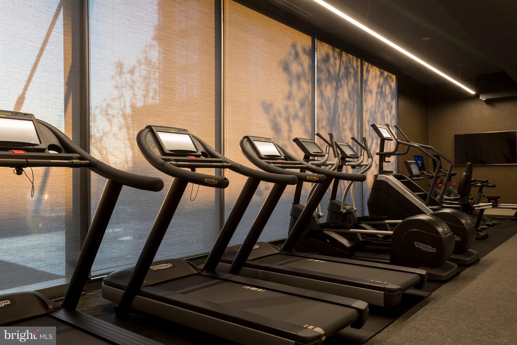 45 Sutton Square Southwest, Unit PH20 Washington, DC 20024 - Photo 20 of 21 a view of gym equipment with large windows