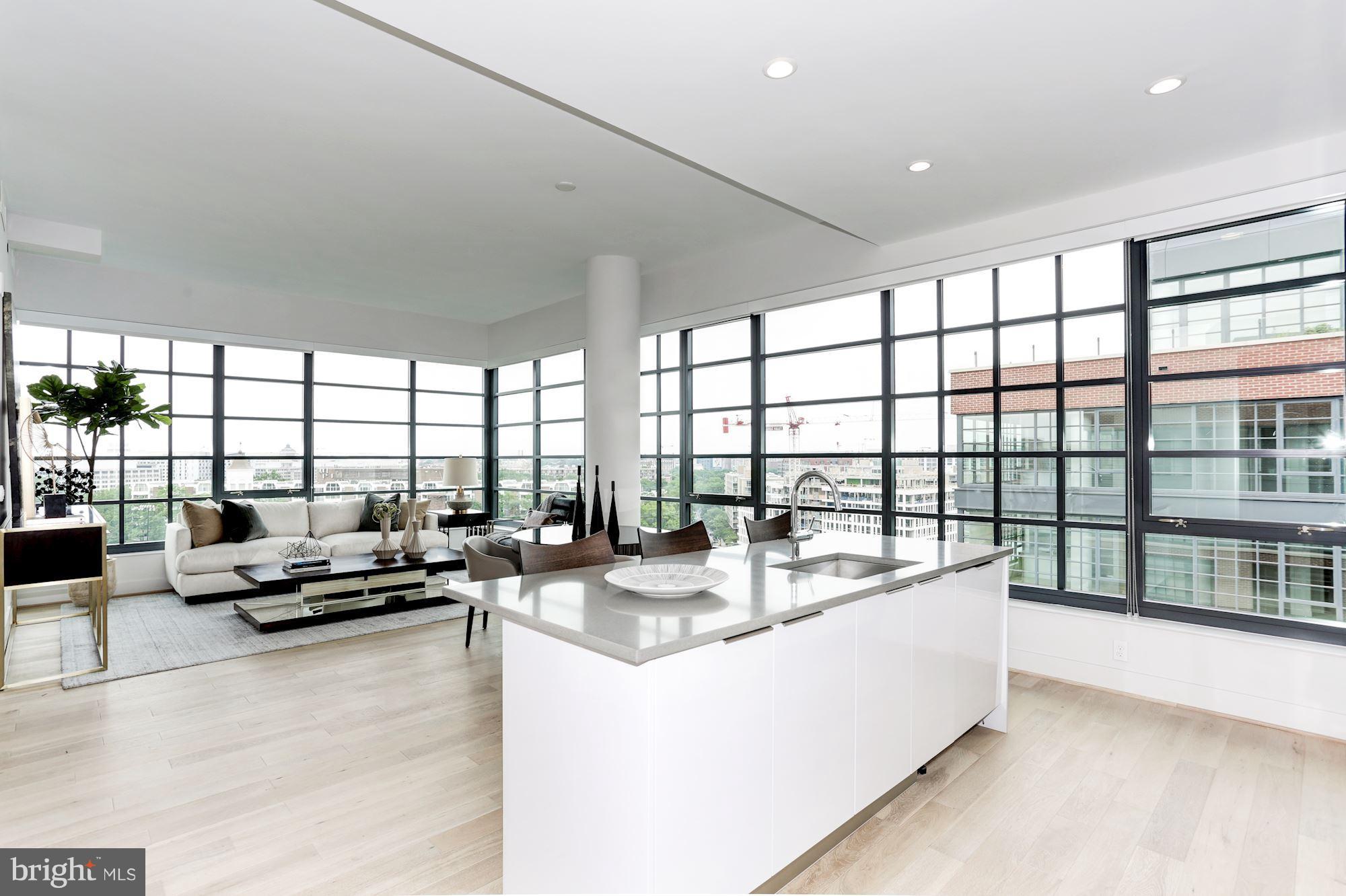 45 Sutton Square Southwest, Unit PH20 Washington, DC 20024 - Photo 2 of 21 a dining hall with couches a coffee table and chairs in front of a room