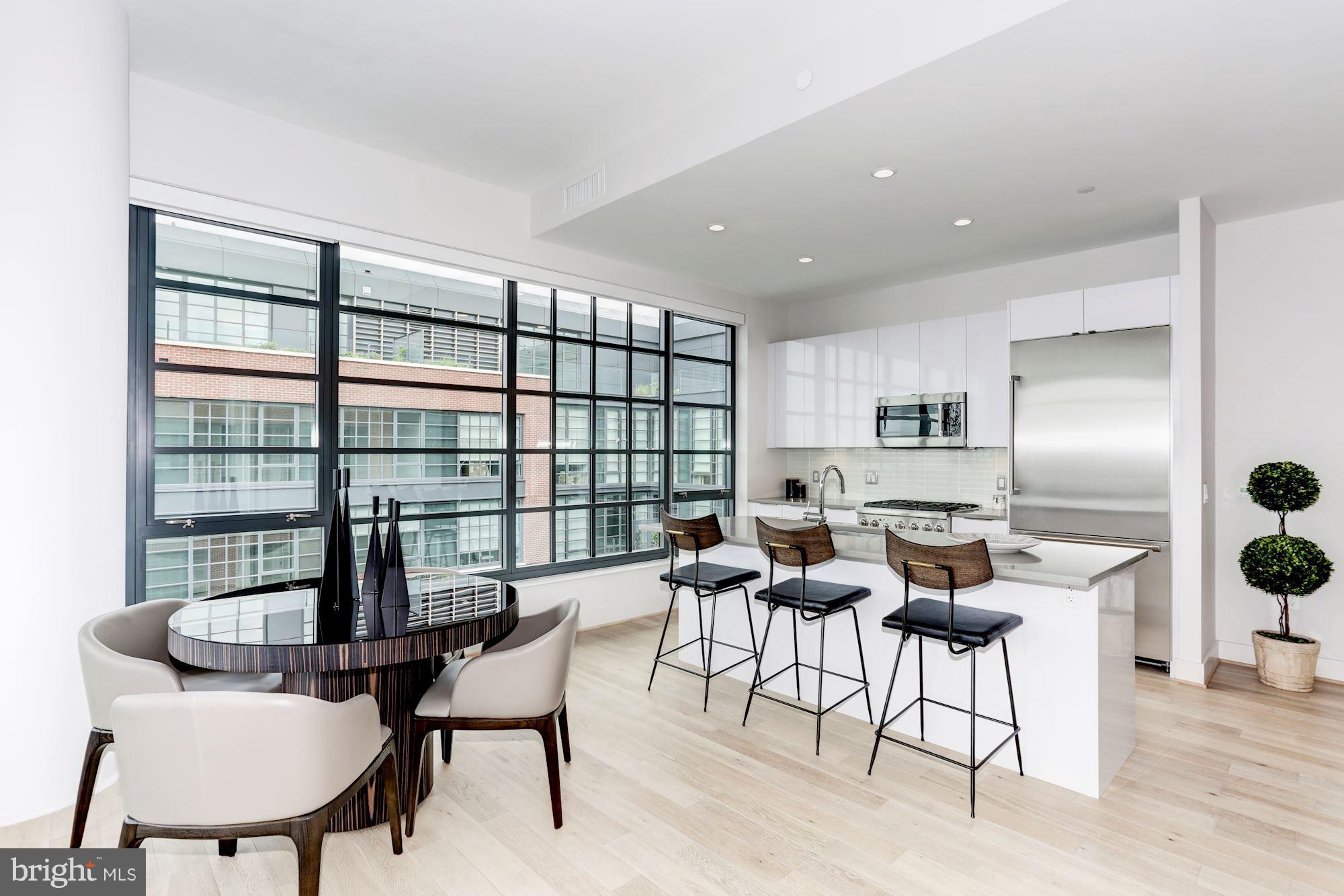 45 Sutton Square Southwest, Unit PH20 Washington, DC 20024 - Photo 5 of 21 a dining room with furniture and wooden floor