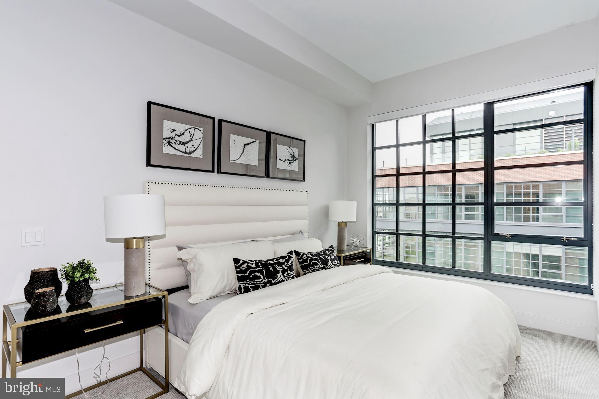 45 Sutton Square Southwest, Unit PH20 Washington, DC 20024 - Photo 7 of 21 a bedroom with a bed and a large window