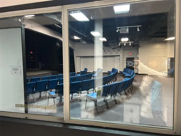 a dining room with glass top table and chairs
