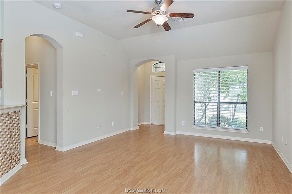 2004 Spring Leaf Court Bryan, TX 77807 - Photo 2 of 19 Unfurnished room with light wood-type flooring, baseboards, arched walkways, visible vents, and a ceiling fan