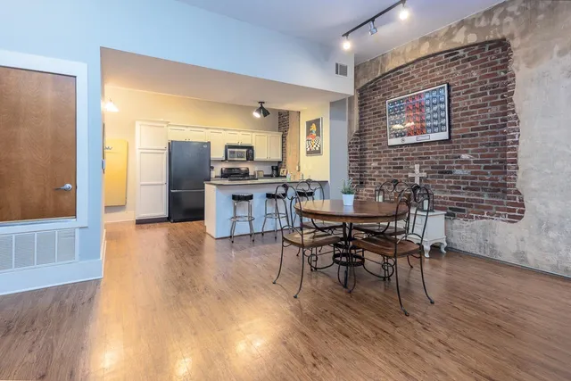 a view of a dining room with furniture and wooden floor