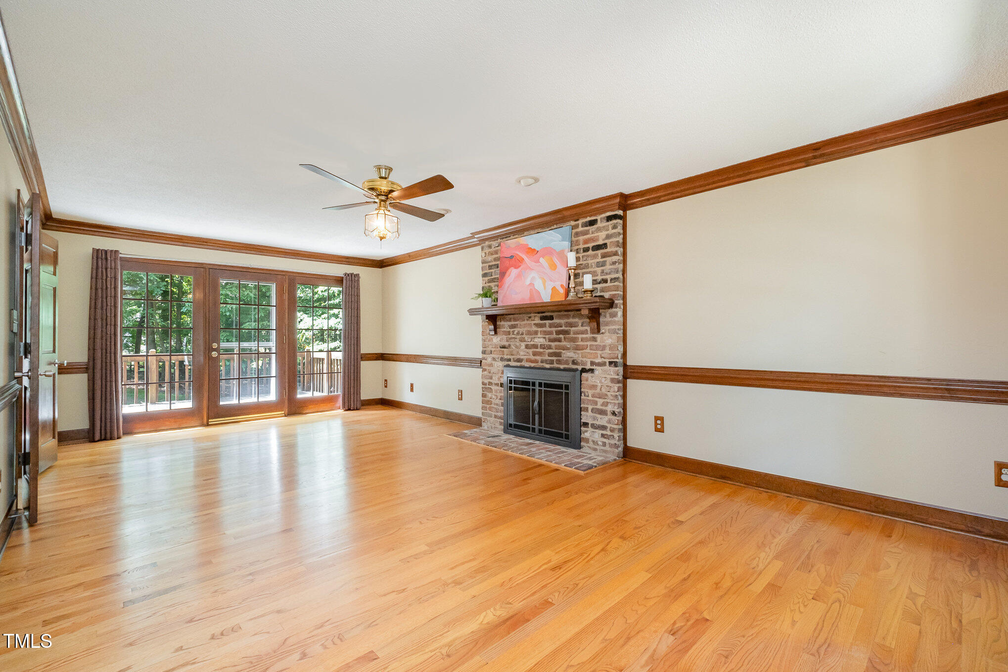 103 Donna Place Cary, NC 27513 - Photo 8 of 35 a view of an empty room with a fireplace and a large window