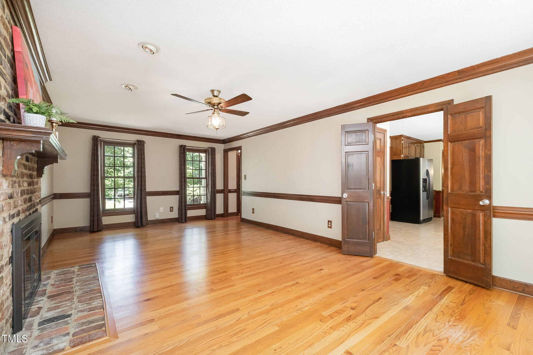103 Donna Place Cary, NC 27513 - Photo 12 of 35 a view of a livingroom with wooden floor and a ceiling fan