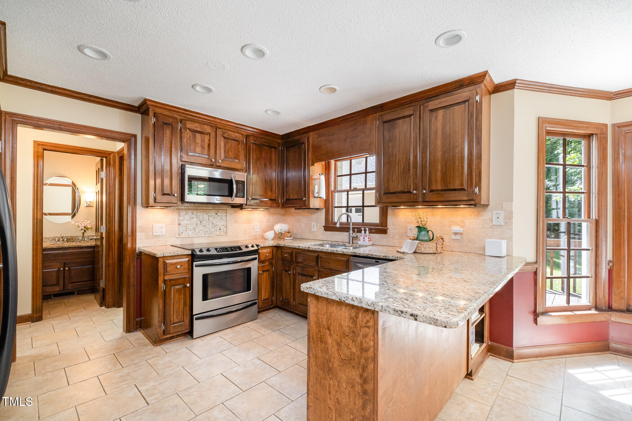 103 Donna Place Cary, NC 27513 - Photo 16 of 35 a kitchen with stainless steel appliances granite countertop a stove sink and cabinets