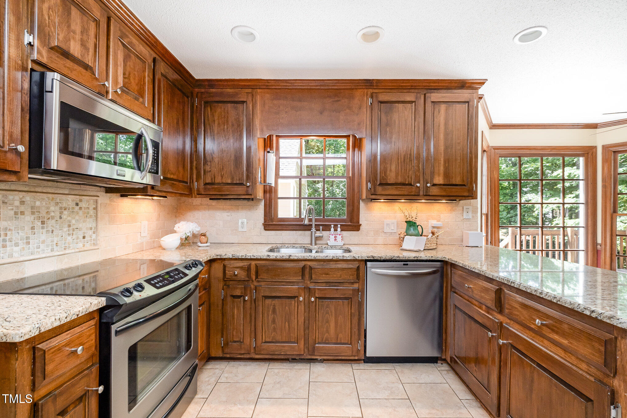 103 Donna Place Cary, NC 27513 - Photo 6 of 35 a kitchen with stainless steel appliances granite countertop a sink and a stove