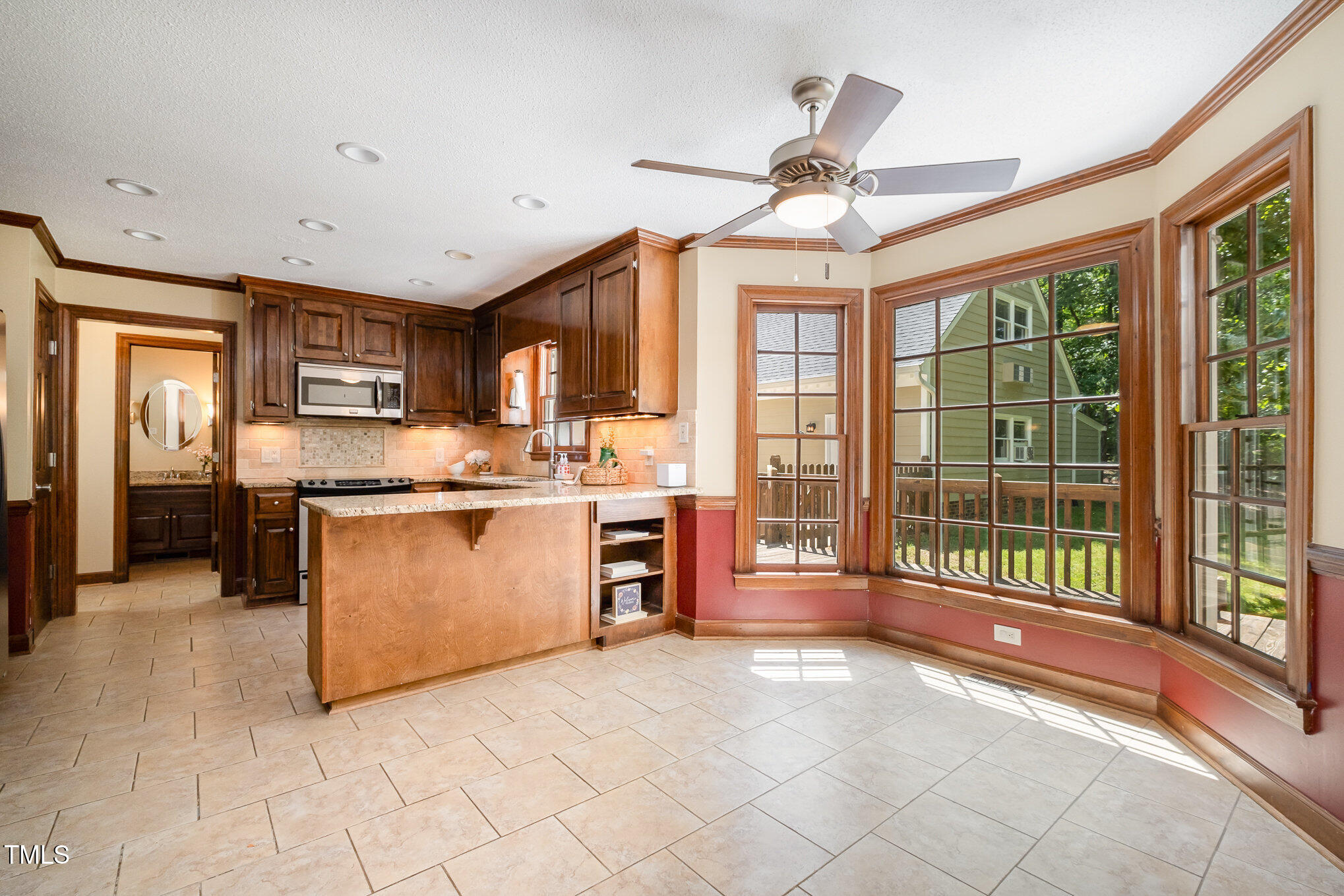103 Donna Place Cary, NC 27513 - Photo 7 of 35 a open kitchen with stainless steel appliances granite countertop a stove top oven a refrigerator a sink and a chandelier