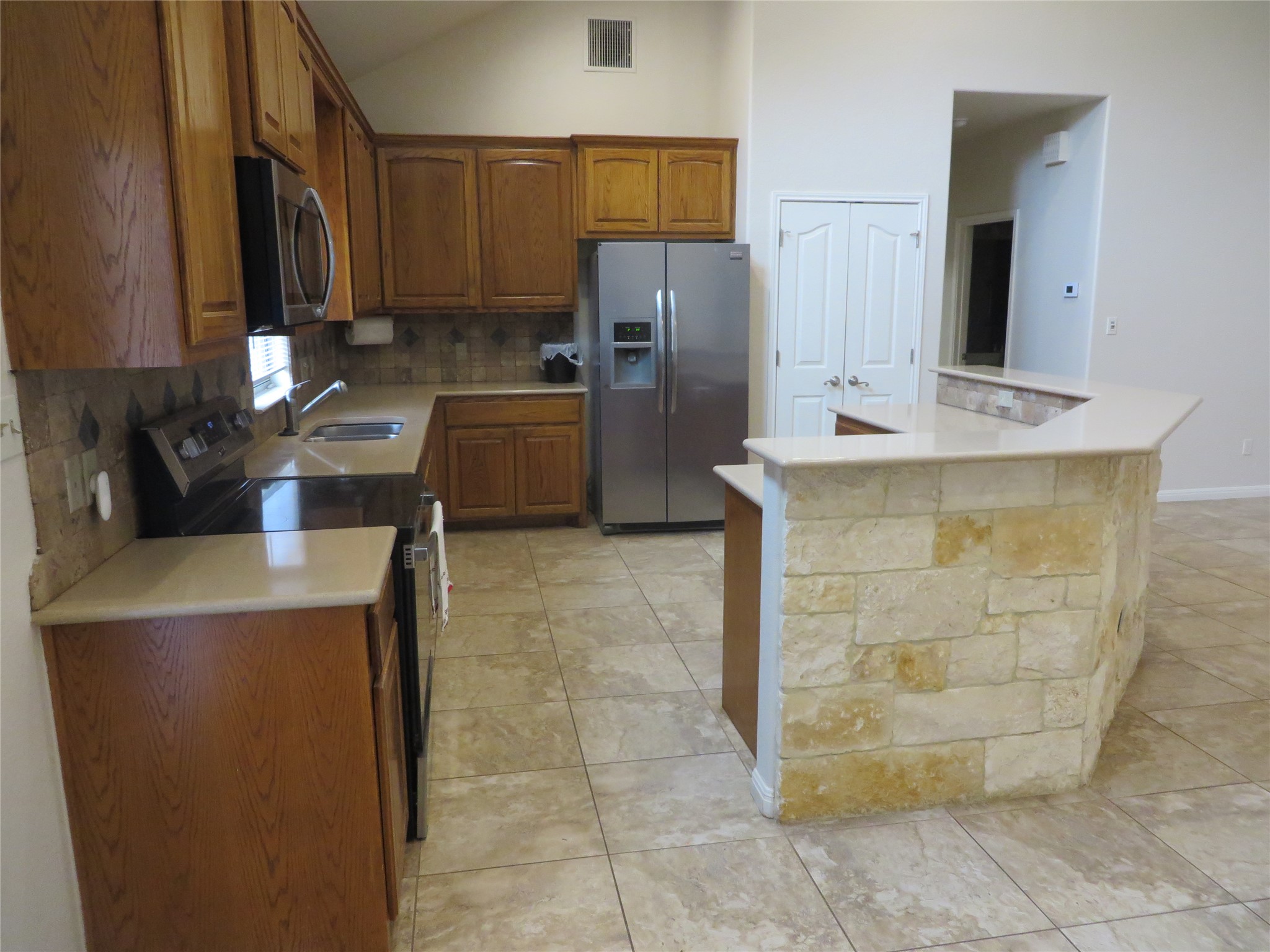 1761 Cottonwood Road Fischer, TX 78623 - Photo 18 of 29 a kitchen with stainless steel appliances a refrigerator sink and cabinets