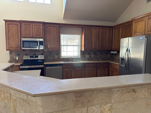 1761 Cottonwood Road Fischer, TX 78623 - Photo 19 of 29 a kitchen with granite countertop a refrigerator and a stove top oven
