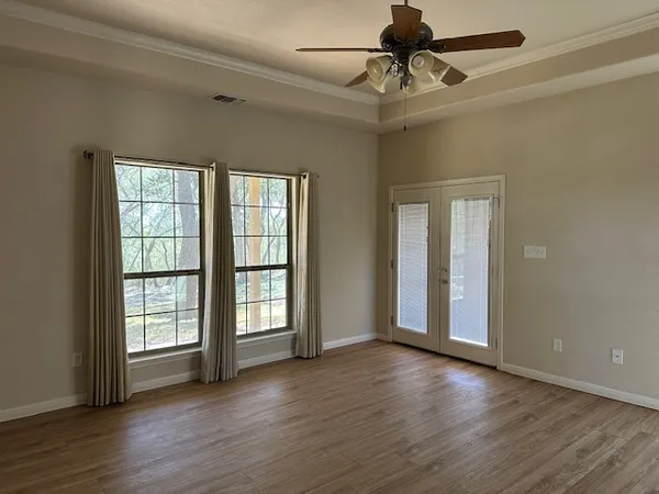 a view of an empty room with a fireplace and a flat screen tv
