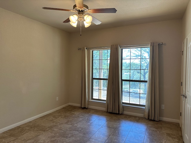 1761 Cottonwood Road Fischer, TX 78623 - Photo 26 of 29 an empty room with wooden floor fan and windows