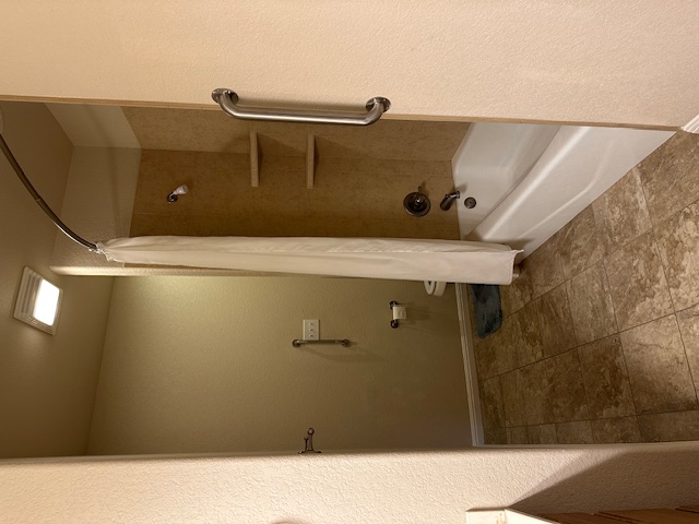 1761 Cottonwood Road Fischer, TX 78623 - Photo 27 of 29 a bathroom with a tub and shower