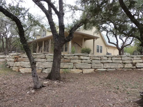a house that has a tree in front of the house