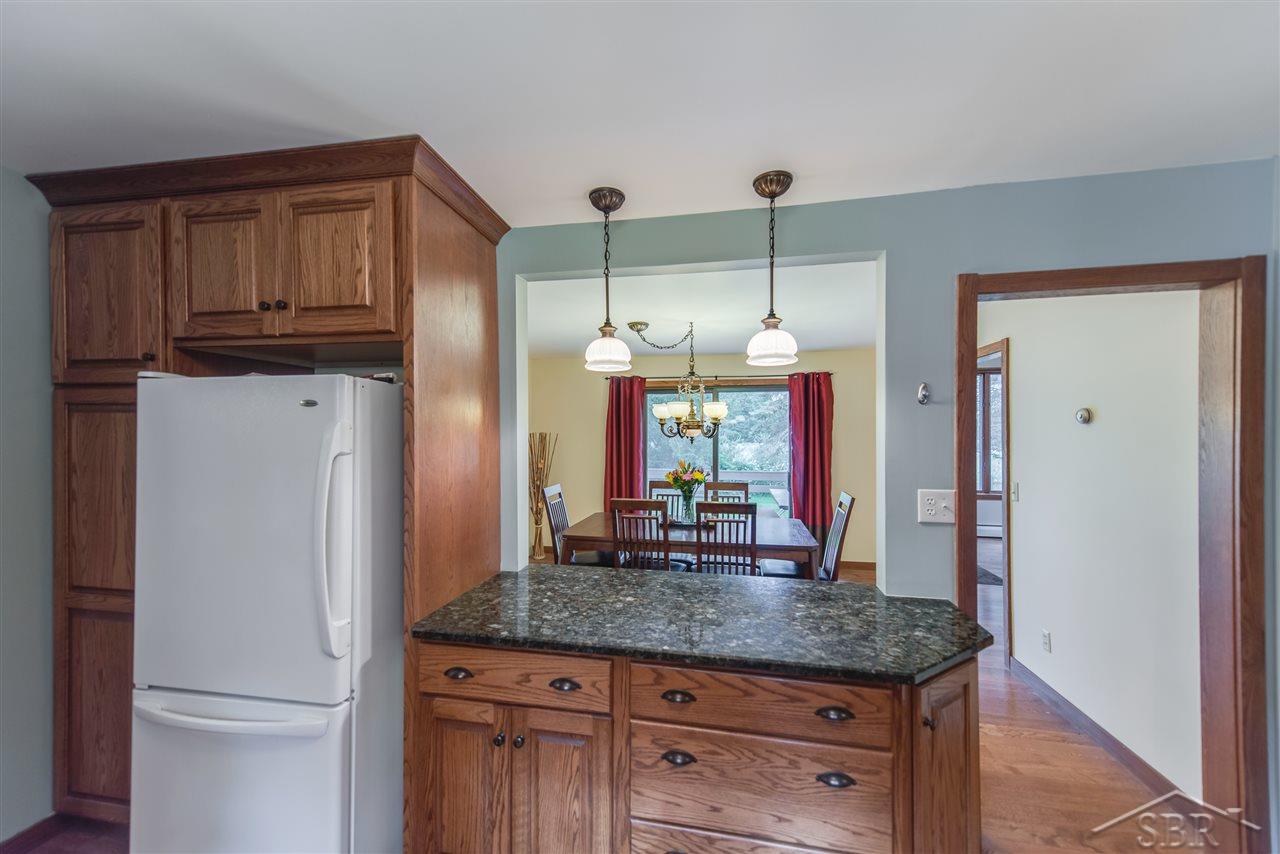 3201 Pomranky Road Midland, MI 48640 - Photo 8 of 29 The granite bar overlooks the dining room.