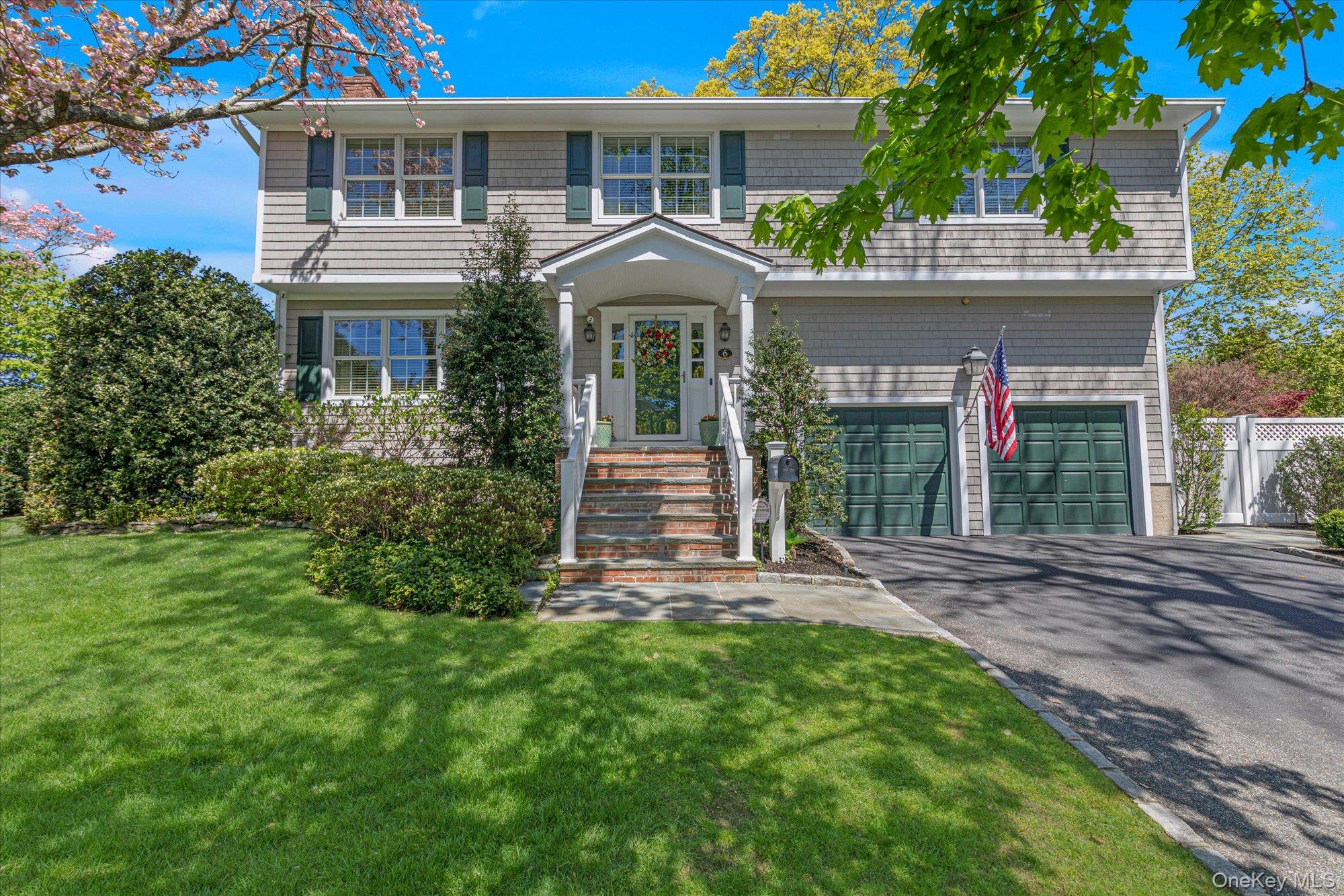 6 Maple Avenue Locust Valley, NY 11560 - Photo 1 of 21 a front view of a house with garden