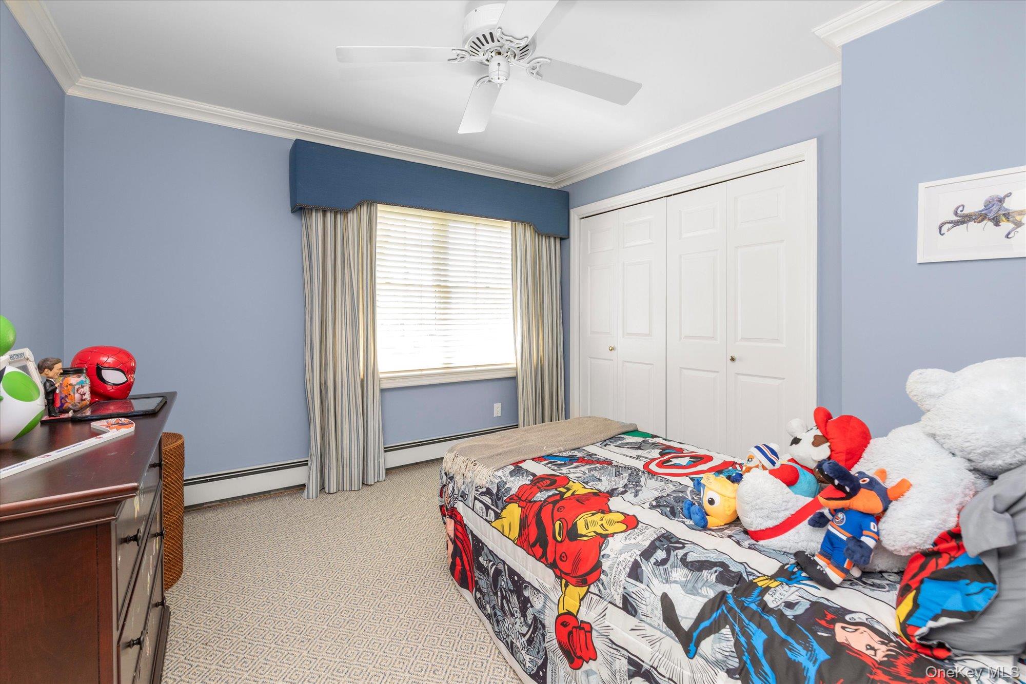 6 Maple Avenue Locust Valley, NY 11560 - Photo 14 of 21 a bedroom with a bed and ceiling fan