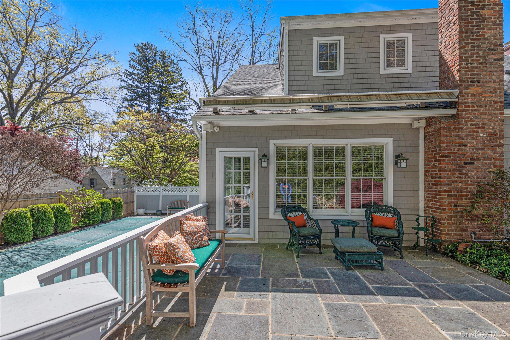 6 Maple Avenue Locust Valley, NY 11560 - Photo 18 of 21 a view of house with a chairs and table in a patio