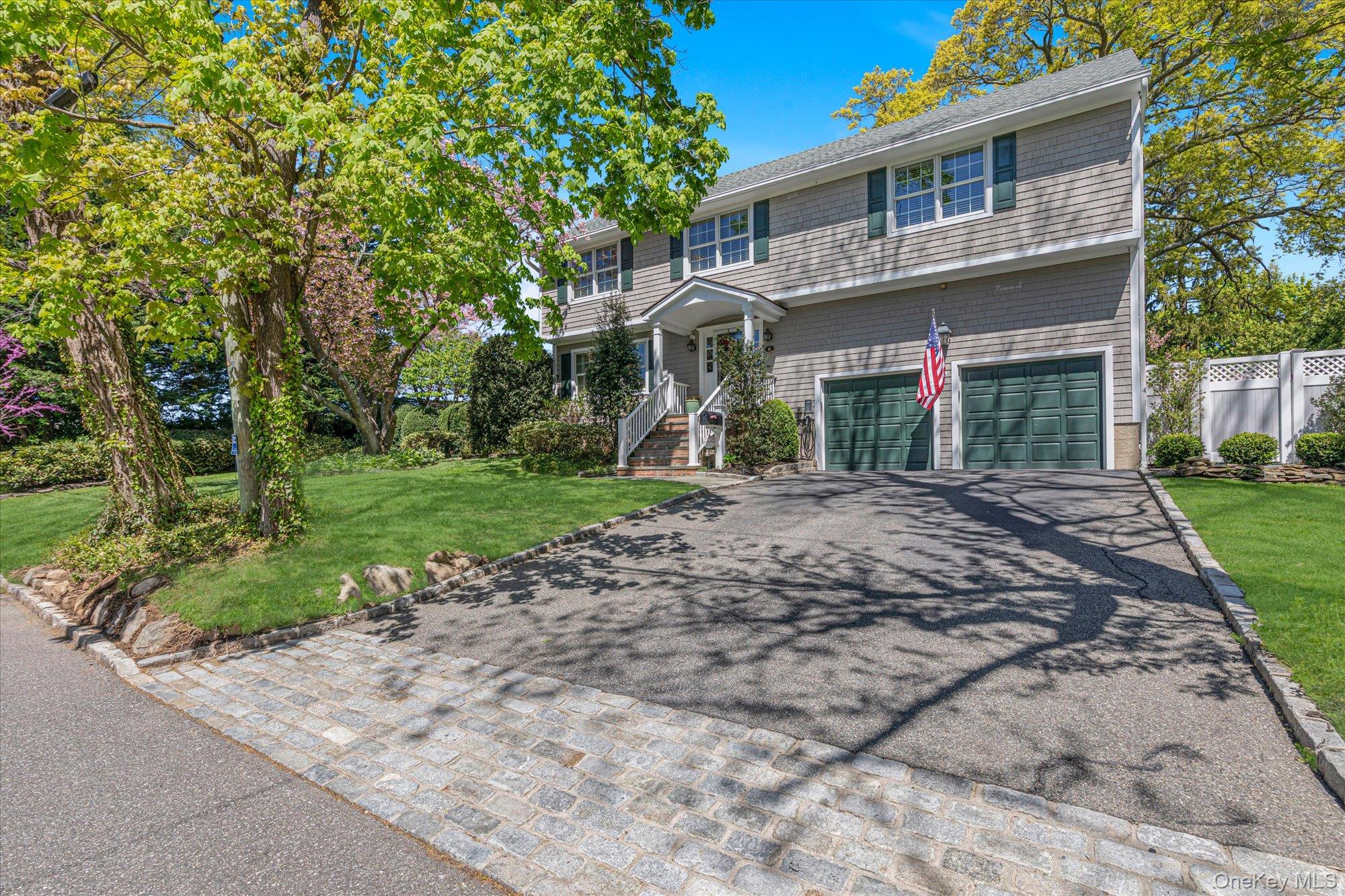 6 Maple Avenue Locust Valley, NY 11560 - Photo 2 of 21 a front view of a house with garden