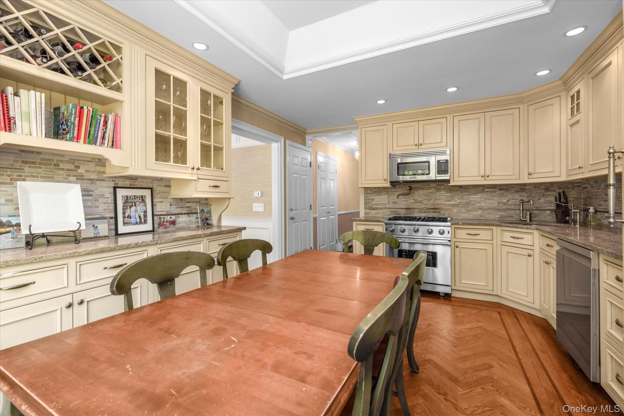 6 Maple Avenue Locust Valley, NY 11560 - Photo 7 of 21 a large kitchen with stainless steel appliances granite countertop a stove a sink a microwave and a refrigerator
