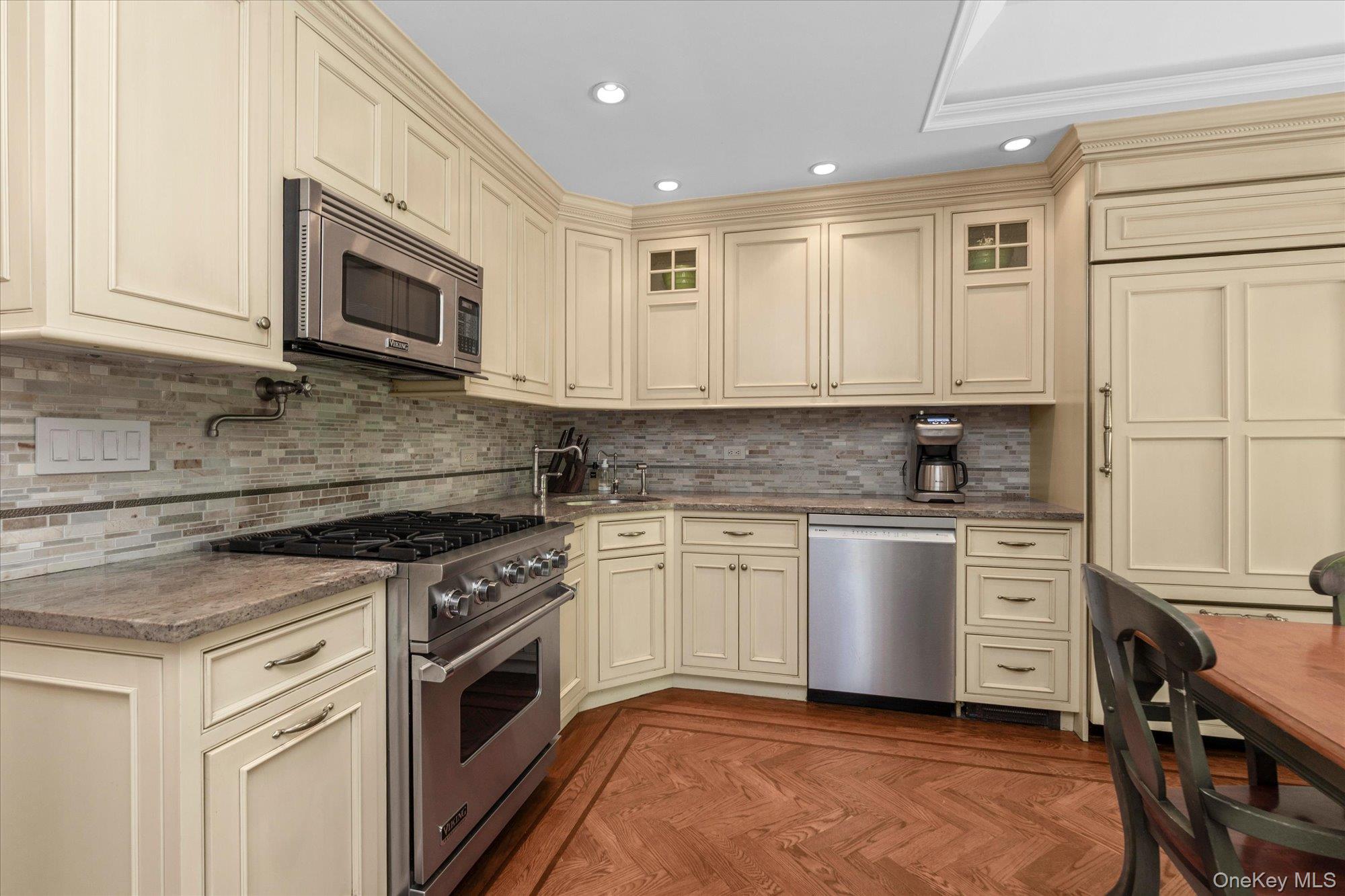 6 Maple Avenue Locust Valley, NY 11560 - Photo 8 of 21 a kitchen with white cabinets stainless steel appliances and sink