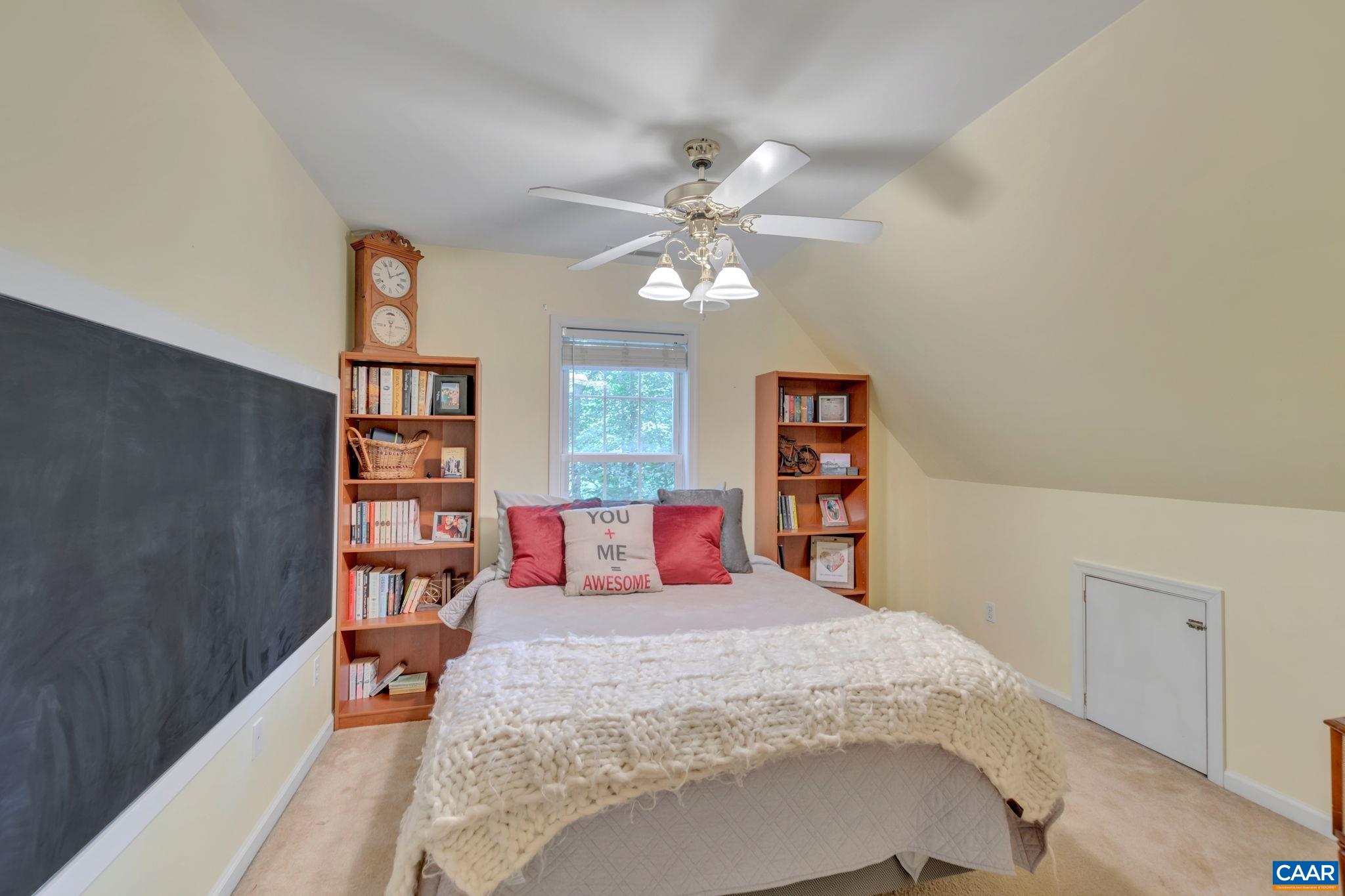 9 Colonial Road Palmyra, VA 22963 - Photo 27 of 49 a bedroom with a large bed and a chandelier