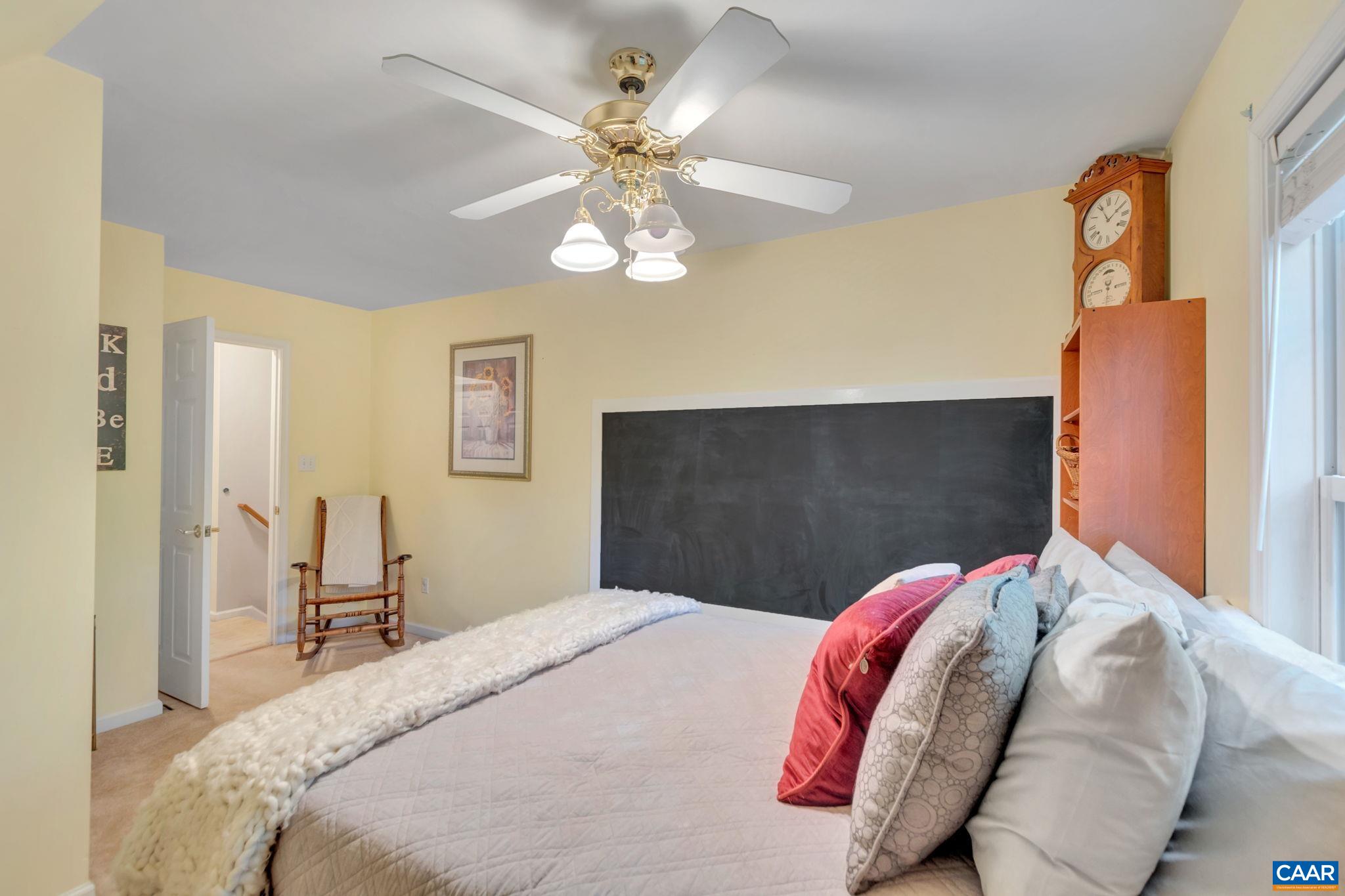 9 Colonial Road Palmyra, VA 22963 - Photo 28 of 49 a bedroom with a bed and a chandelier