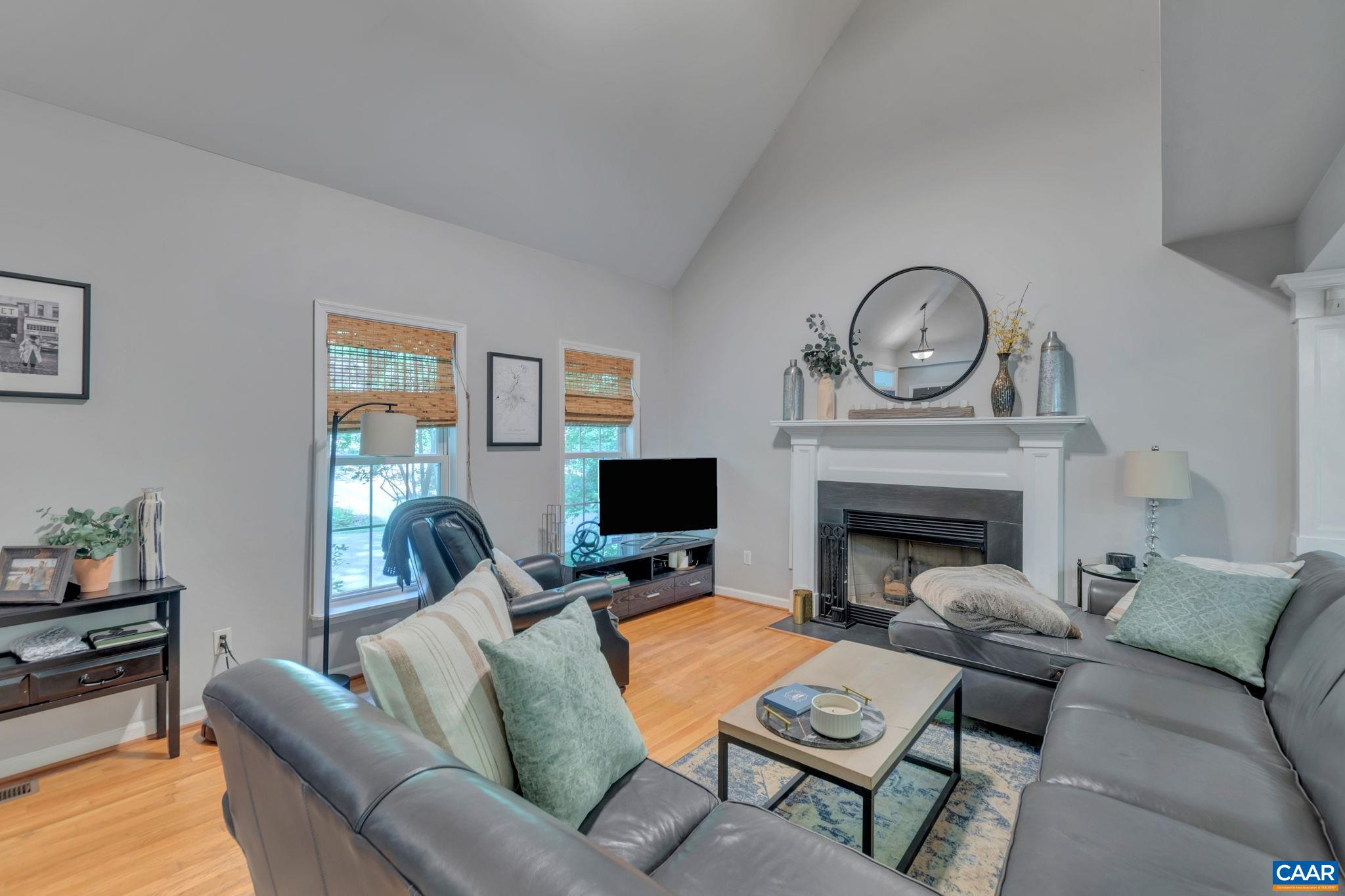9 Colonial Road Palmyra, VA 22963 - Photo 9 of 49 a living room with furniture a fireplace and a flat screen tv